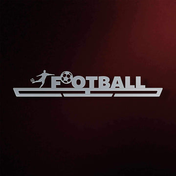 Football Medal Hanger in laser-cut steel on a dark background