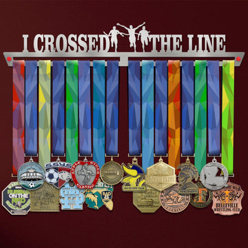 I Crossed The Line Medal Hanger holding a full row of medals on a wall