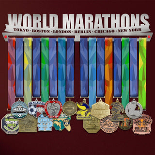 World Marathon Majors Medal Hanger V2 holding a full row of medals on a wall